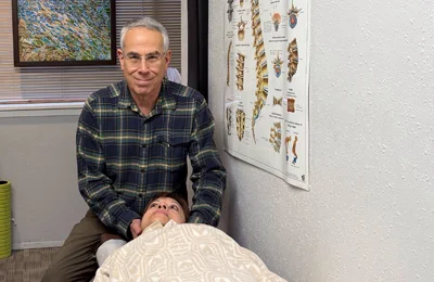 Dr. Siegel performing gentle cervical treatment at CK Chiropractic Office