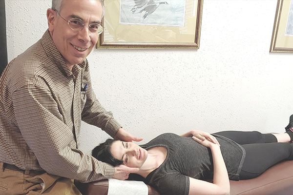 Dr. Siegel performing a gentle neck adjustment in Silverdale, WA